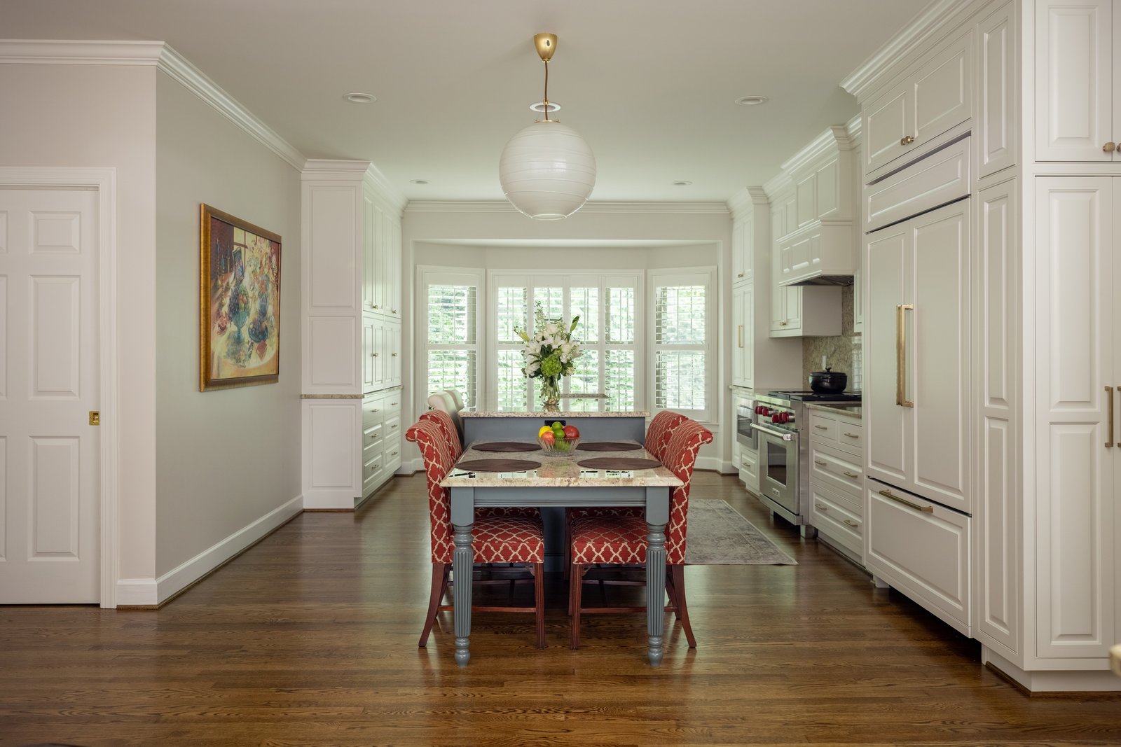 Modern kitchen with white perimeter cabinets and blue gray island