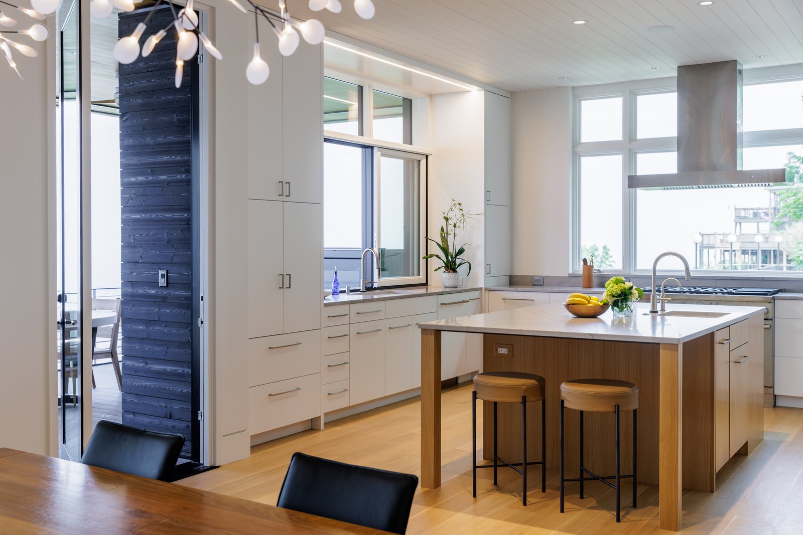 Contemporary white kitchen with natural oak island