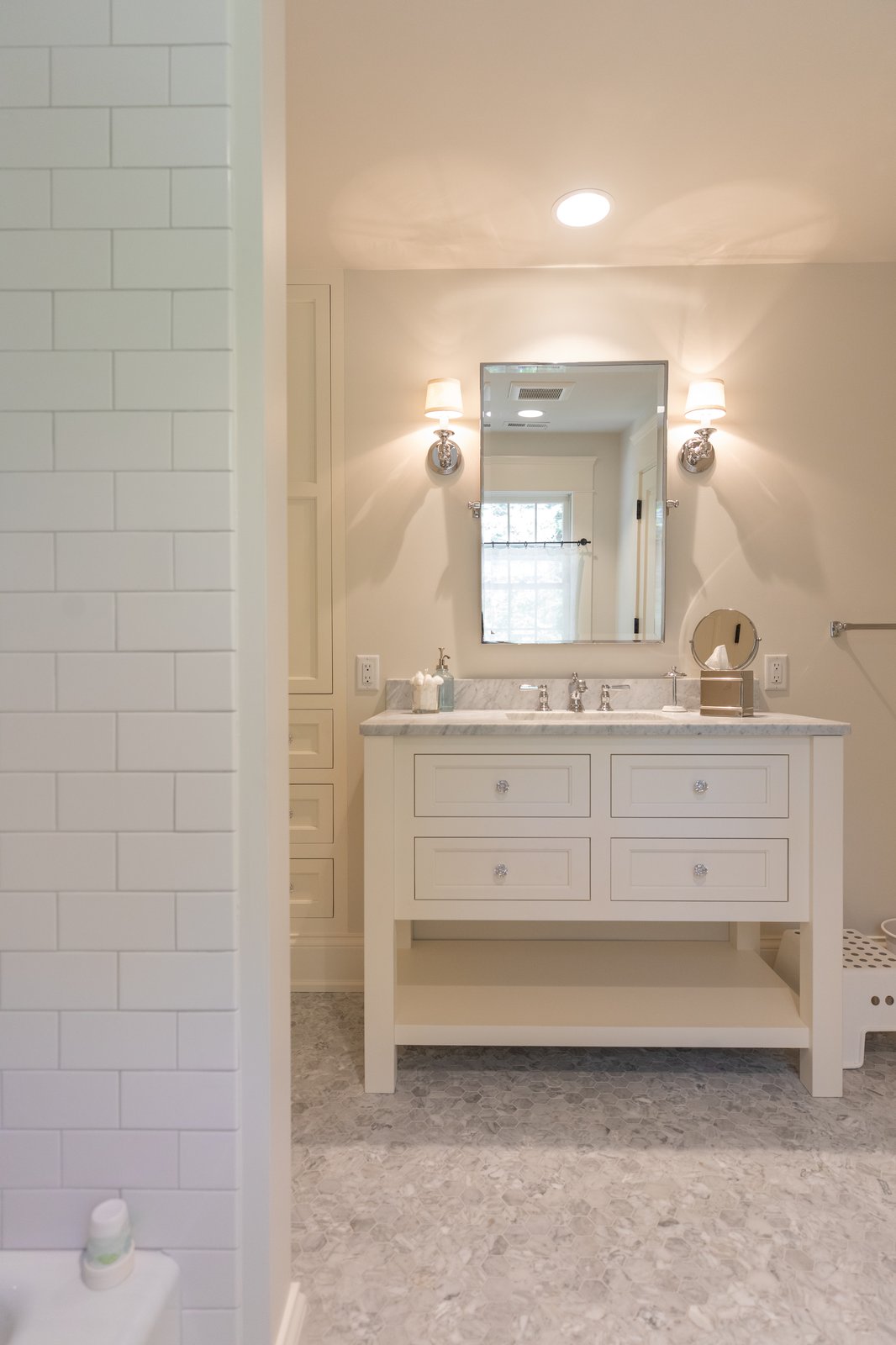 Free-standing white shaker vanity with marble countertop