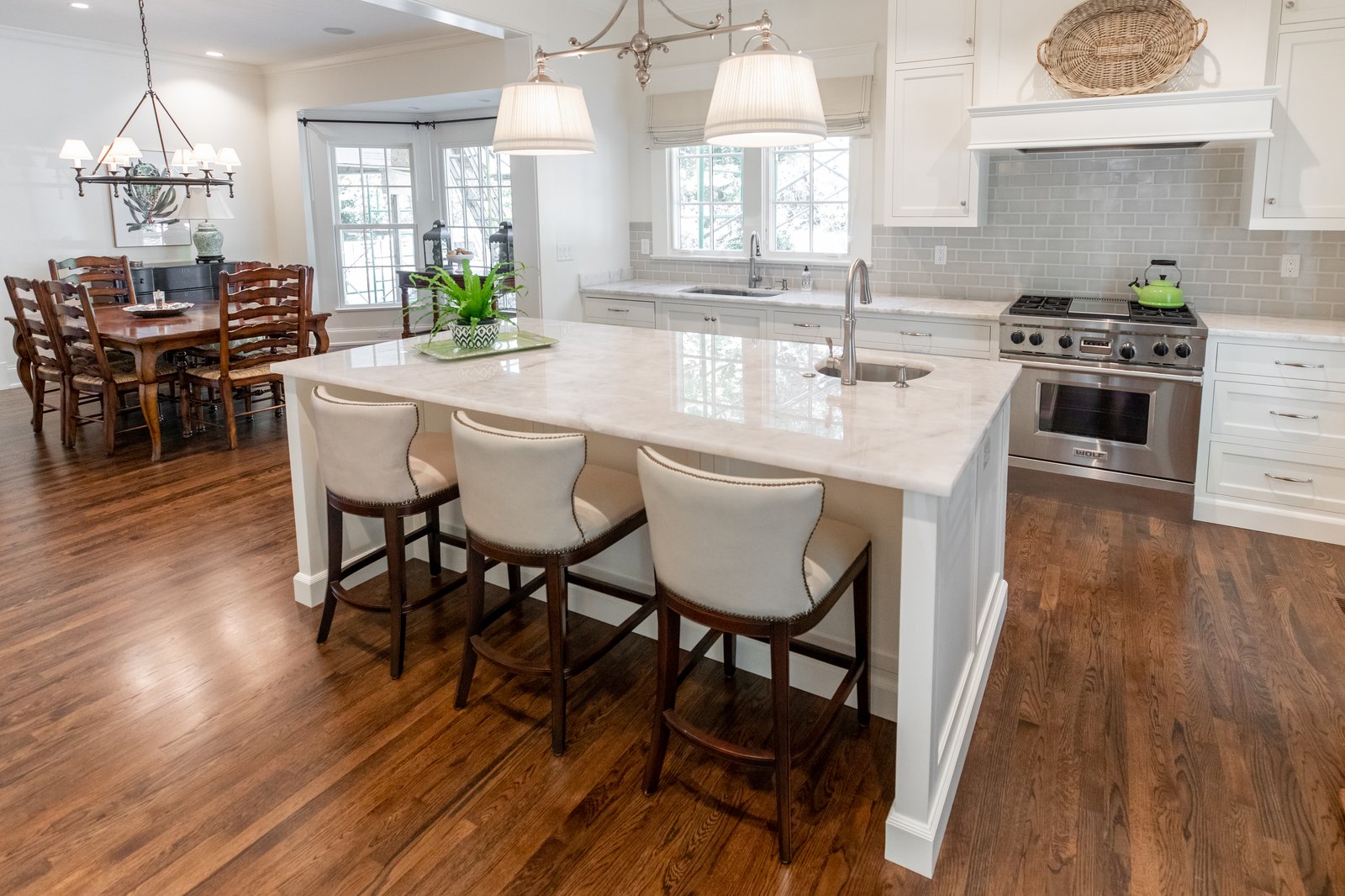 White painted family kitchen with floor to ceiling cabinets